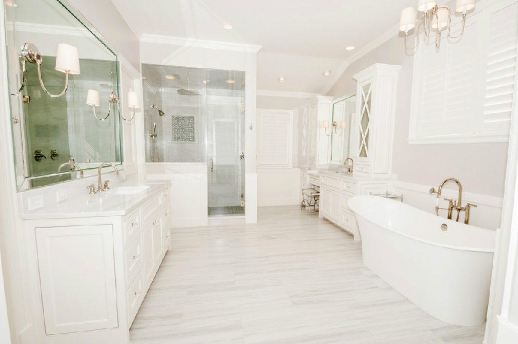 A white bathroom with two sinks and a large mirror.