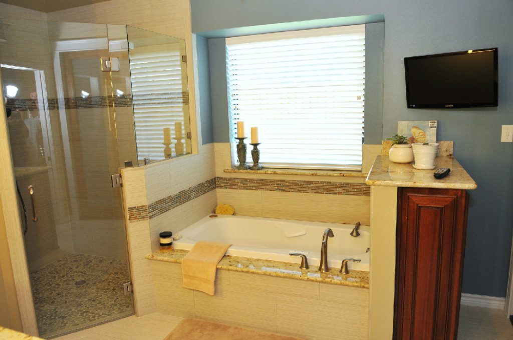 A bathroom with a large tub and shower.