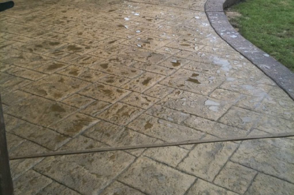 A close up of the sidewalk with water on it