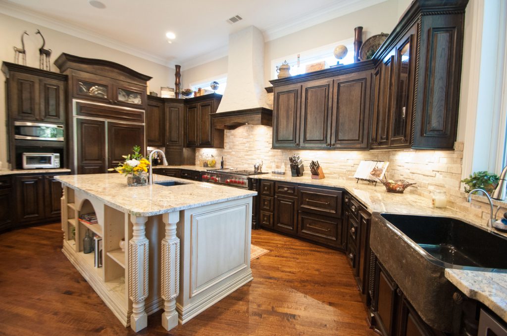 A kitchen with an island and wooden cabinets