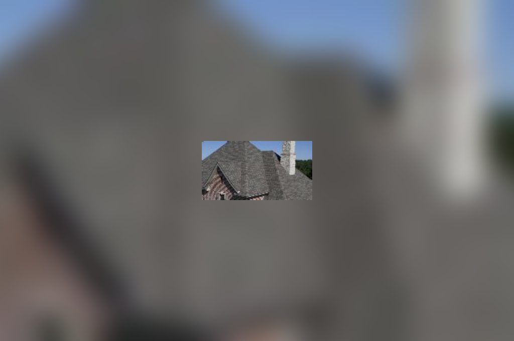 A blurry image of a building with a sky background