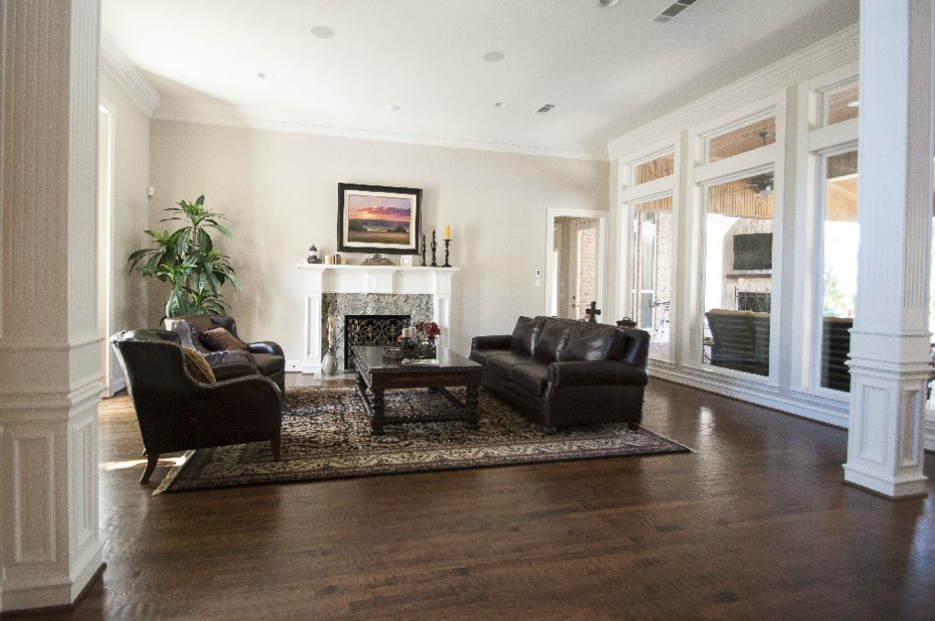 A living room with hardwood floors and furniture.