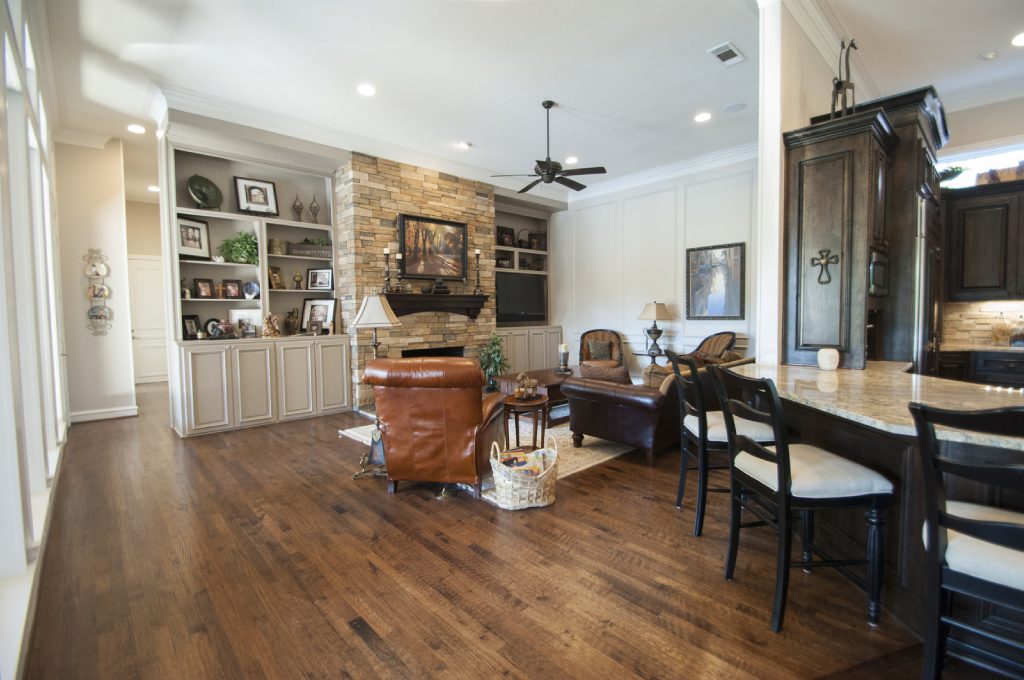 A living room with hard wood floors and furniture.