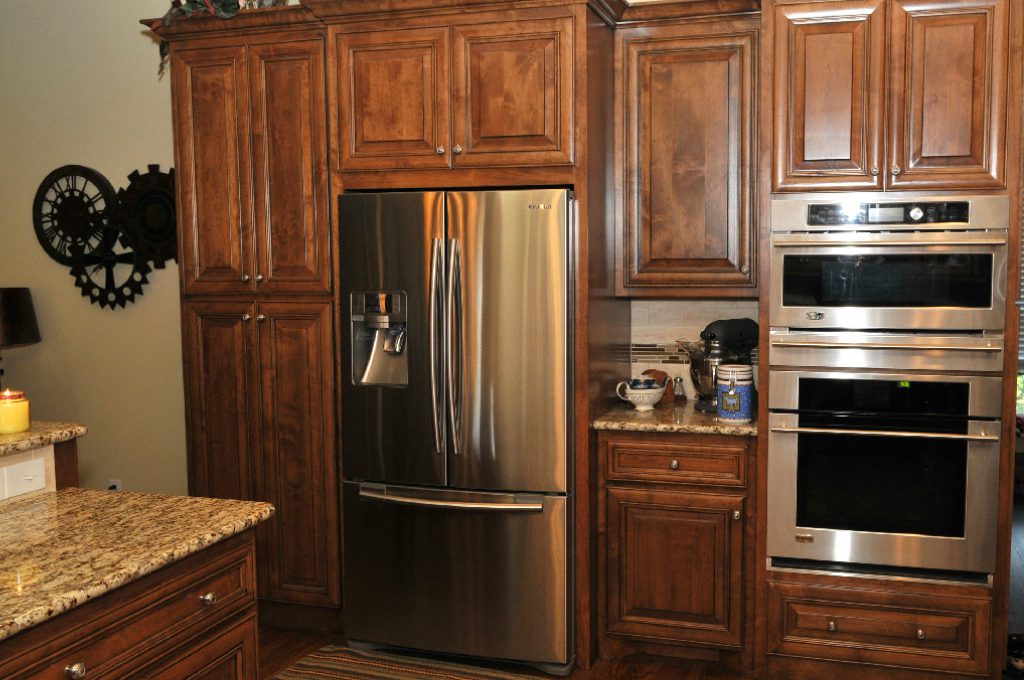 A kitchen with wooden cabinets and stainless steel appliances.