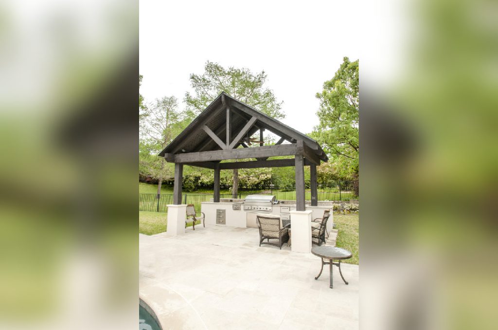 A large outdoor pavilion with chairs and tables.