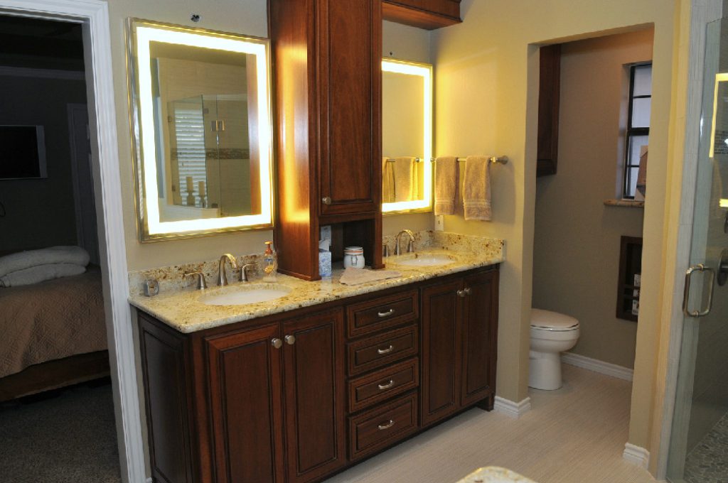 A bathroom with two sinks and a large mirror.