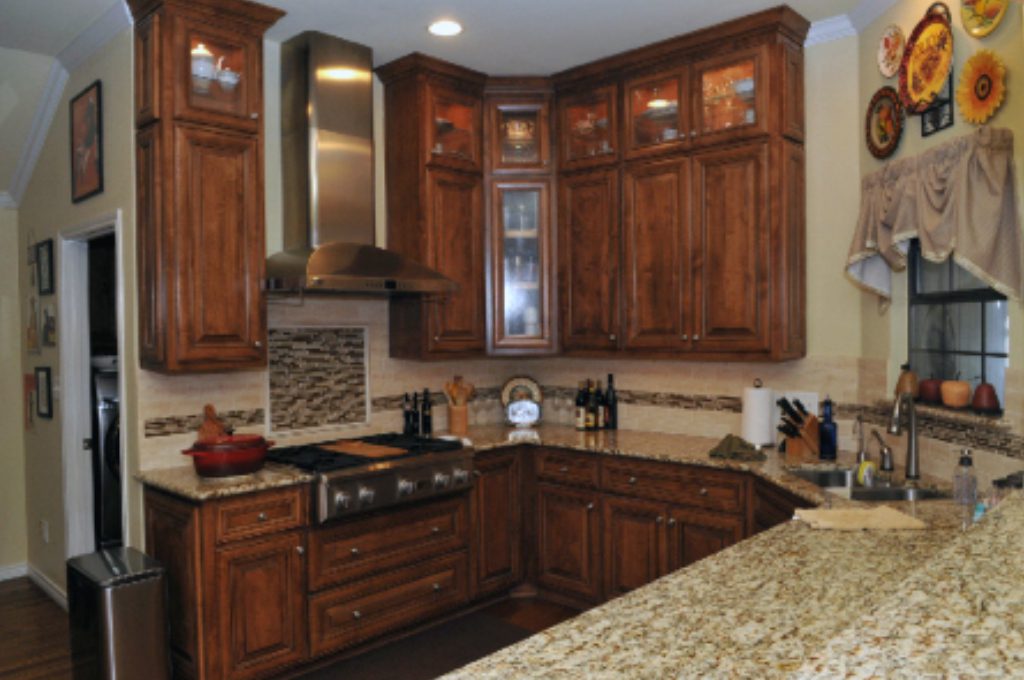 A kitchen with wooden cabinets and granite counter tops.