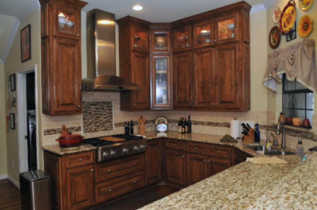 A kitchen with wooden cabinets and granite counter tops.