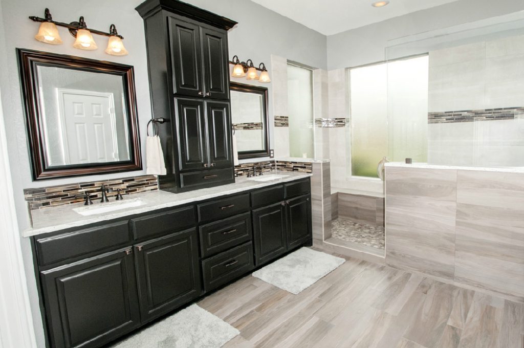 A bathroom with two sinks and a large mirror.