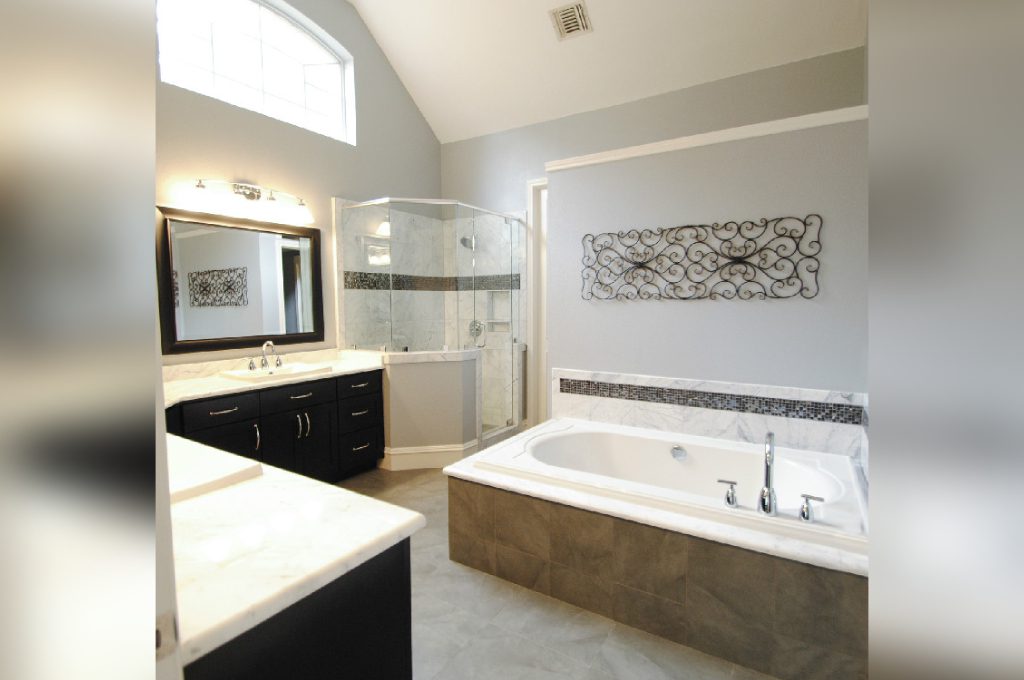 A bathroom with a large tub and sink.