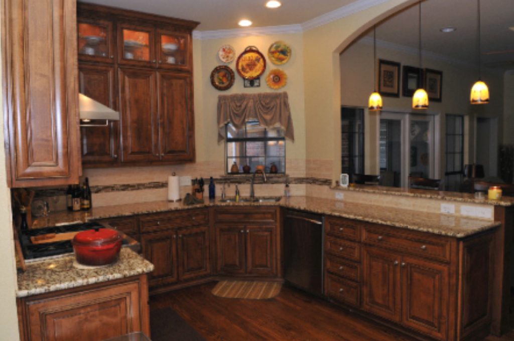 A kitchen with wooden cabinets and granite counter tops.