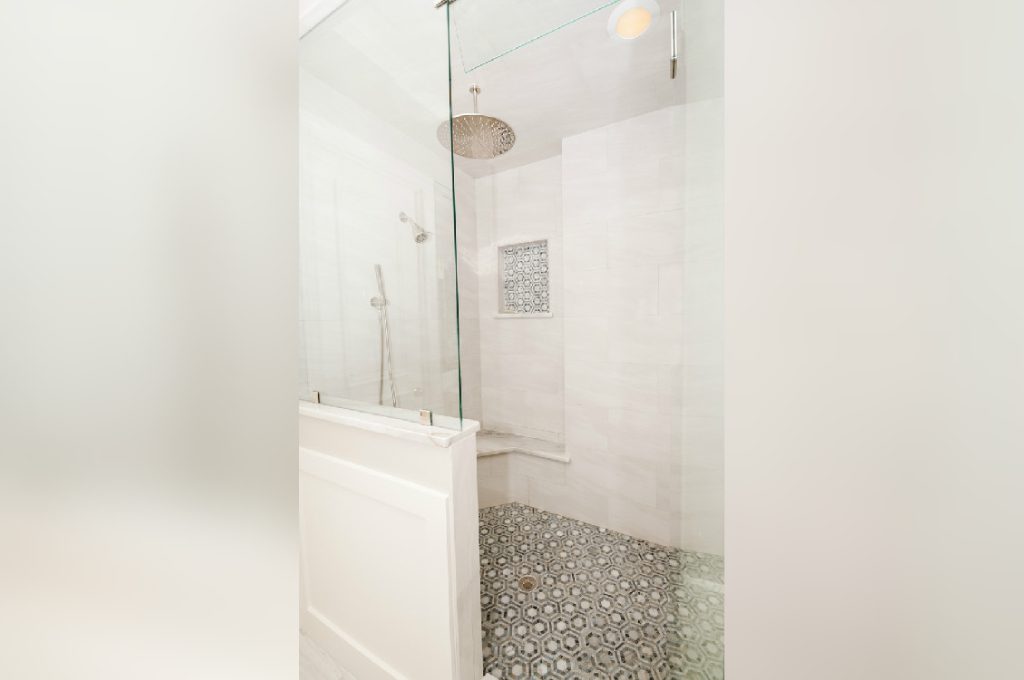 A bathroom with a shower and tiled floor