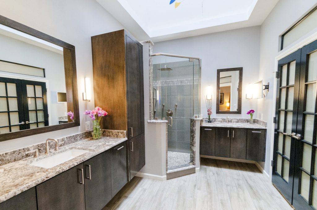 A bathroom with two sinks and a shower.