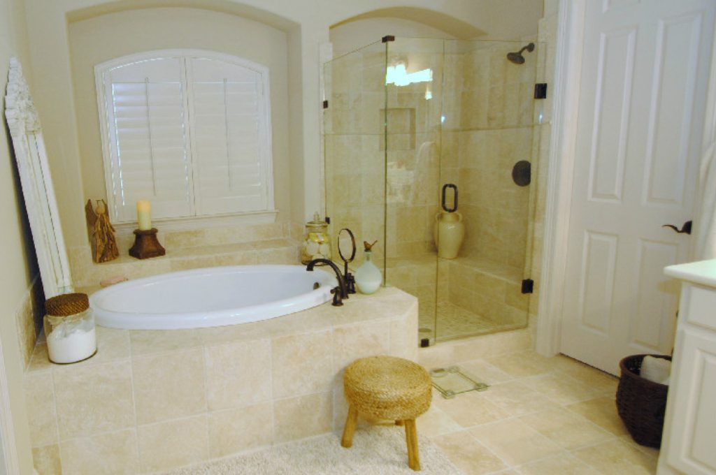 A bathroom with a tub, shower and toilet.