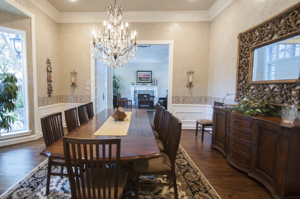 A dining room with a large table and chairs