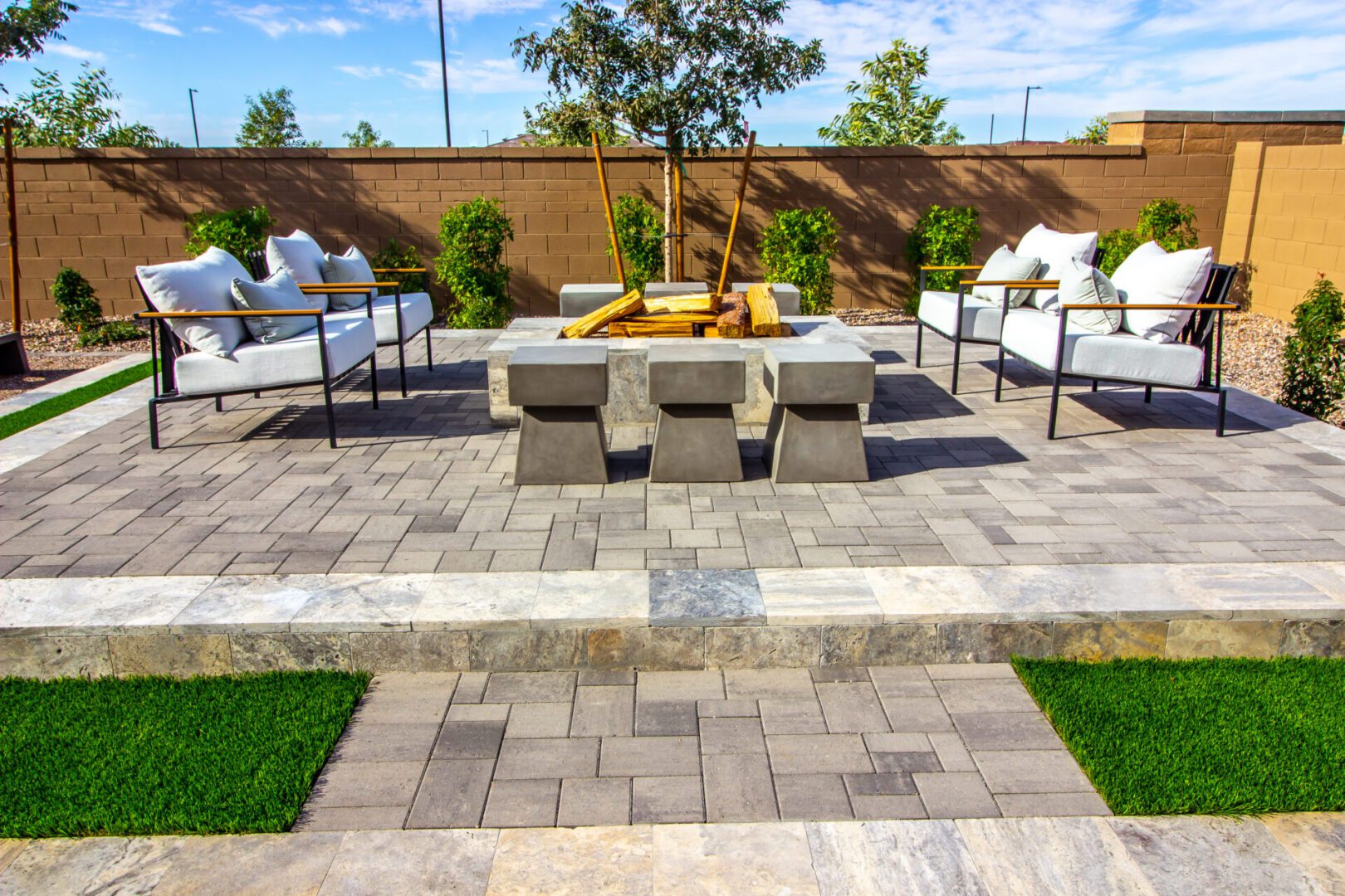 Modern patio with seating and fire pit.