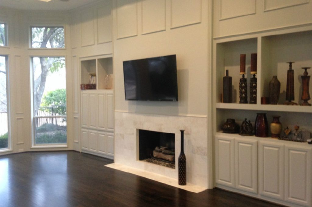 A fireplace with a flat screen tv mounted above it.
