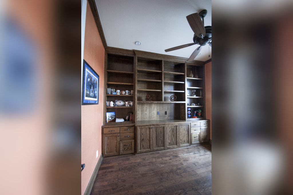 A room with a tv and some shelves