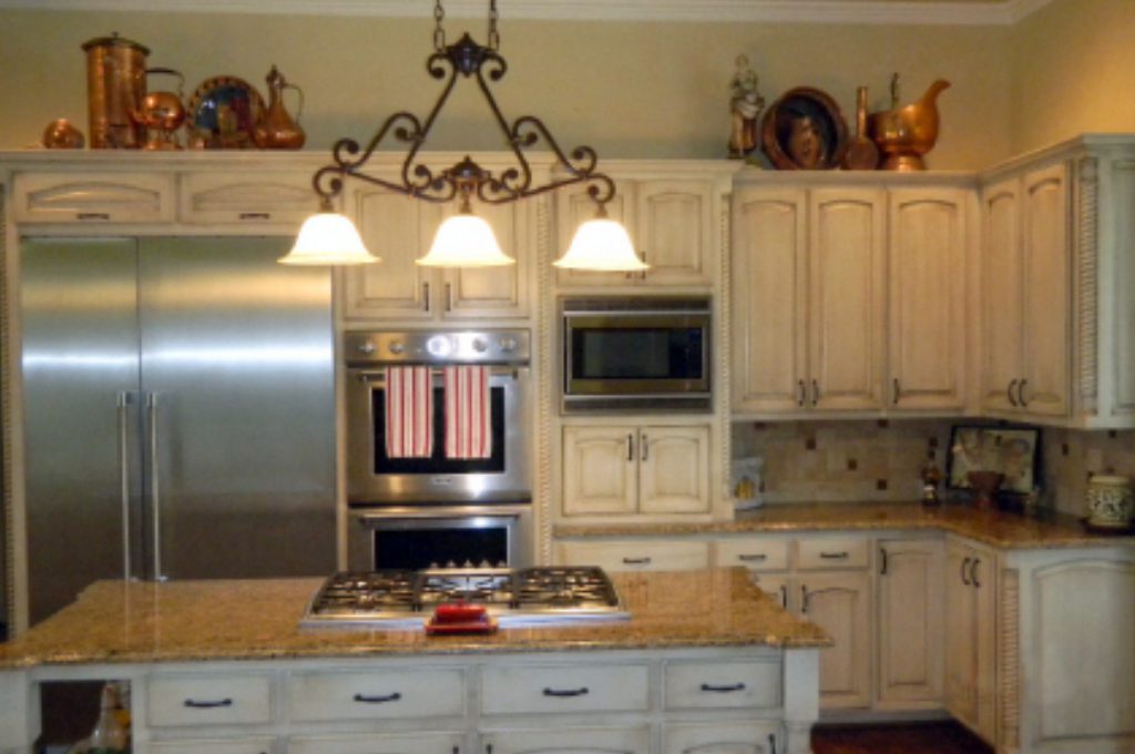 A kitchen with white cabinets and stainless steel appliances.