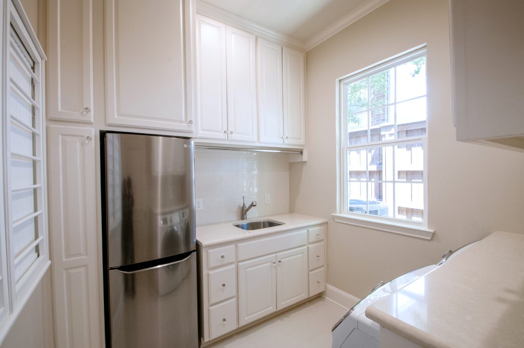 A kitchen with white cabinets and stainless steel appliances.