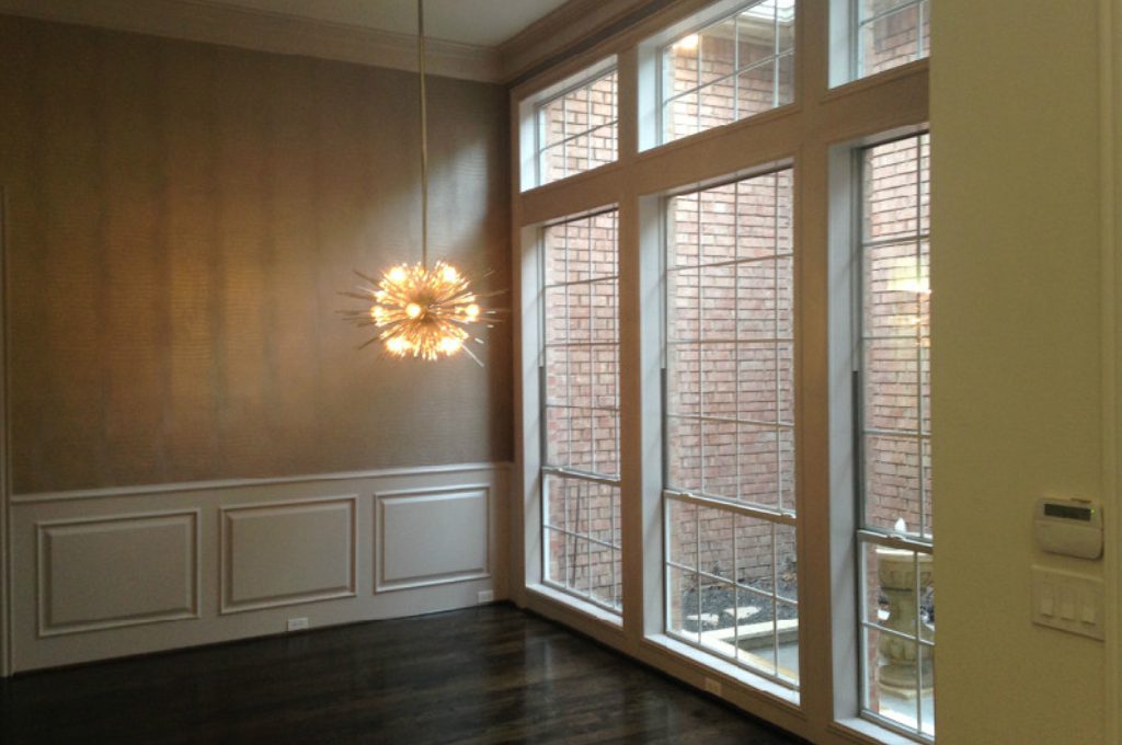 A room with two large windows and a light fixture.