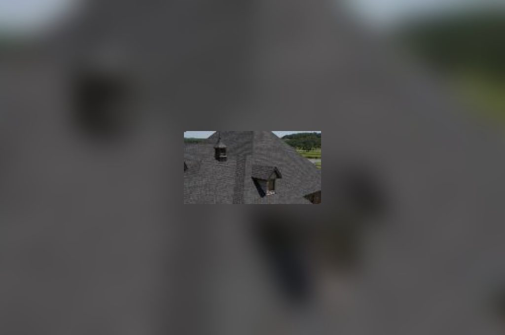 A blurry image of someone walking in the street.