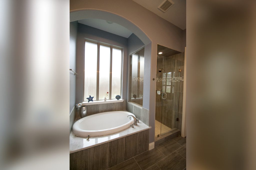 A large bathroom with a tub and shower.