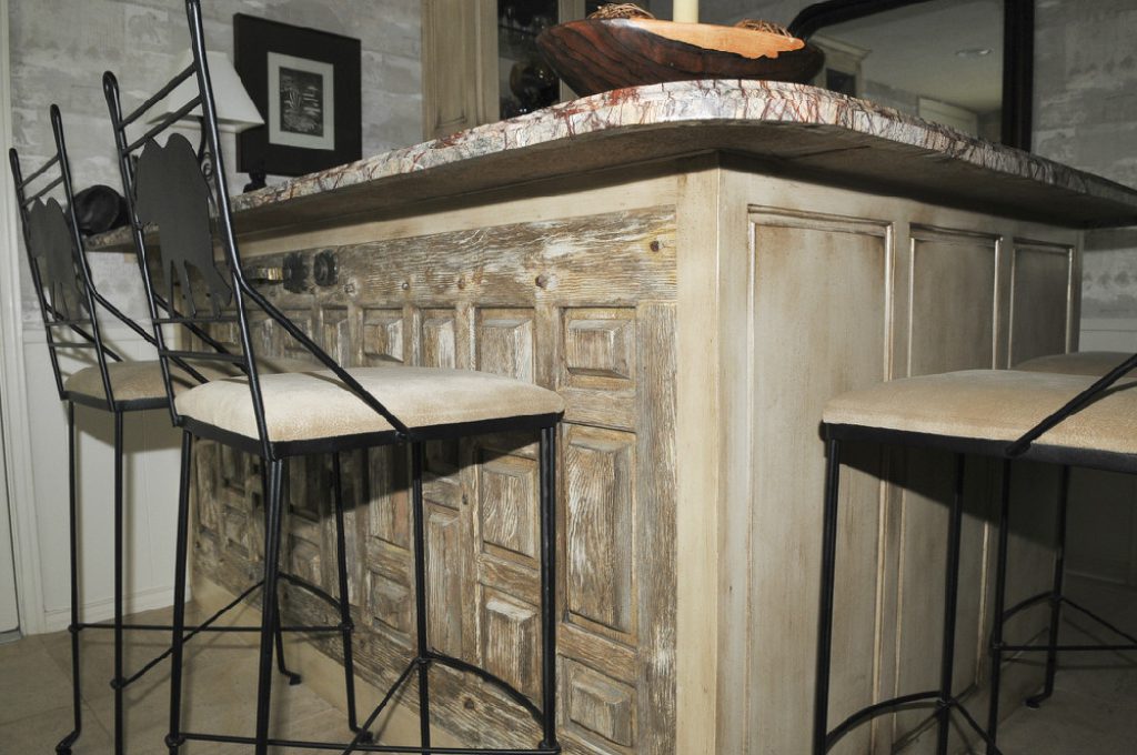 A bar with two stools and a counter top.