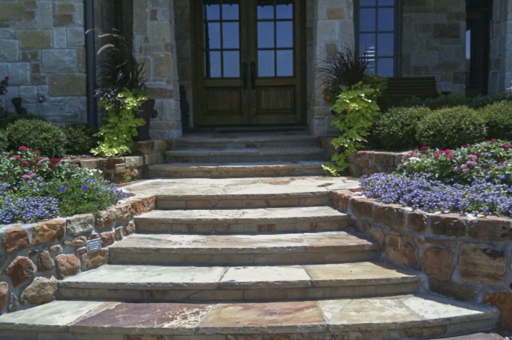 A stone staircase leading to the front door of a house.